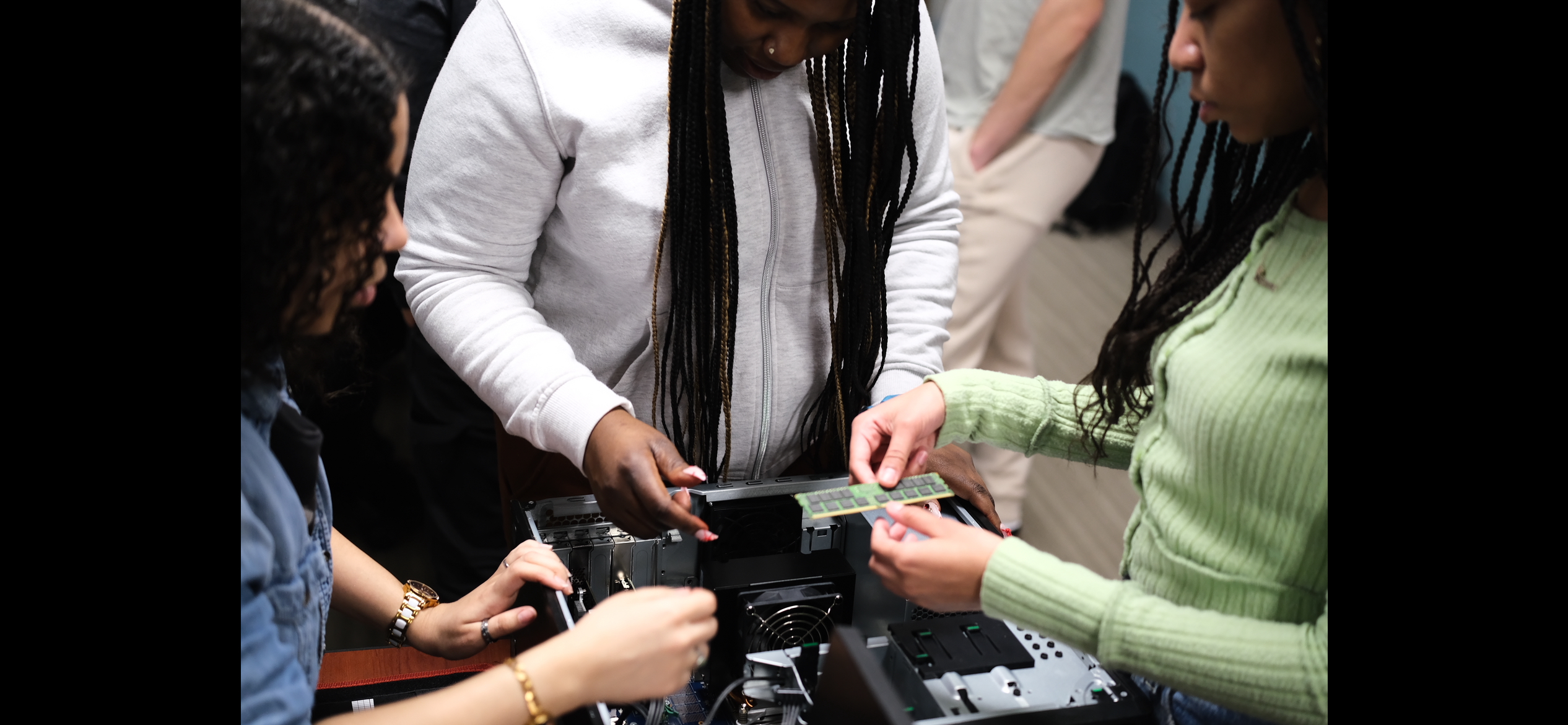Three female students working on a computer