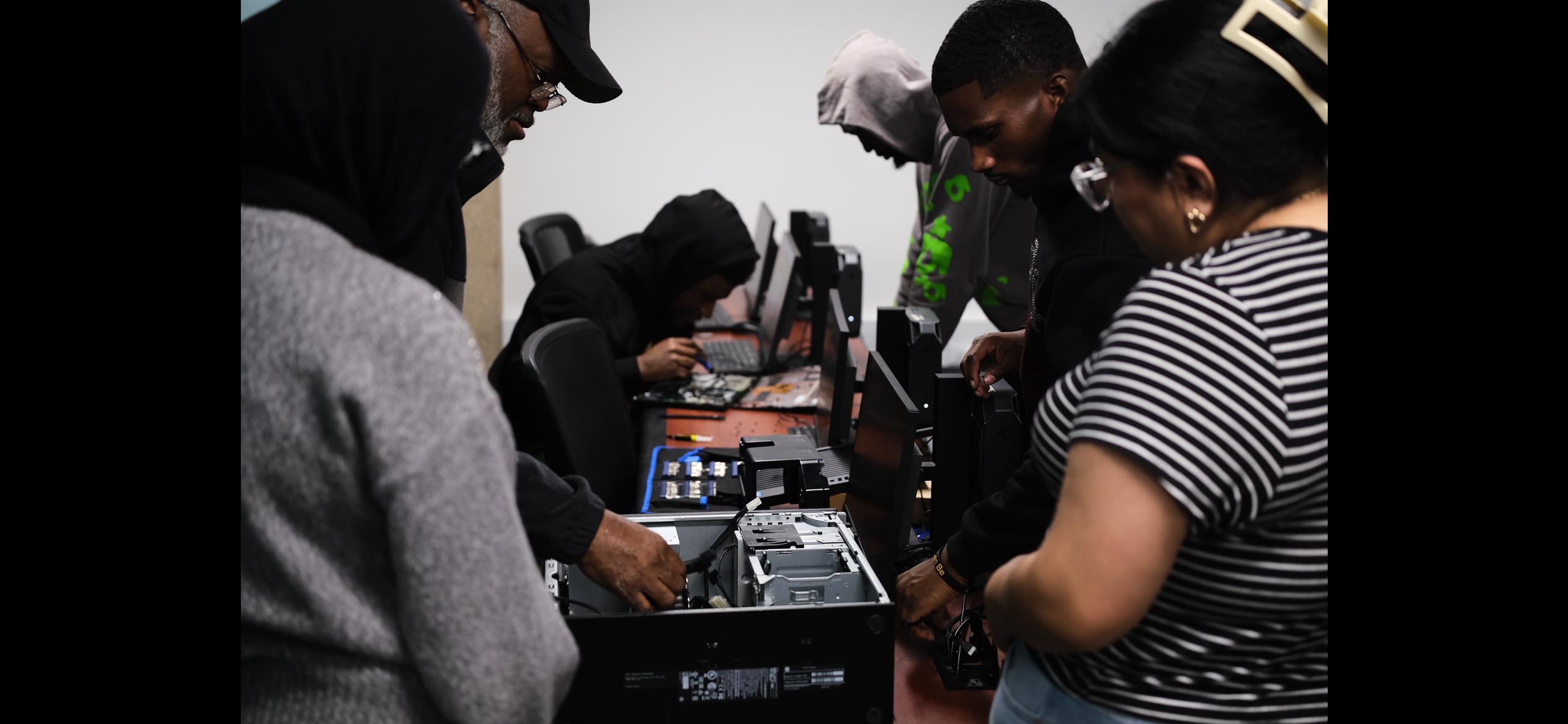 Overhead view of students working with computer parts