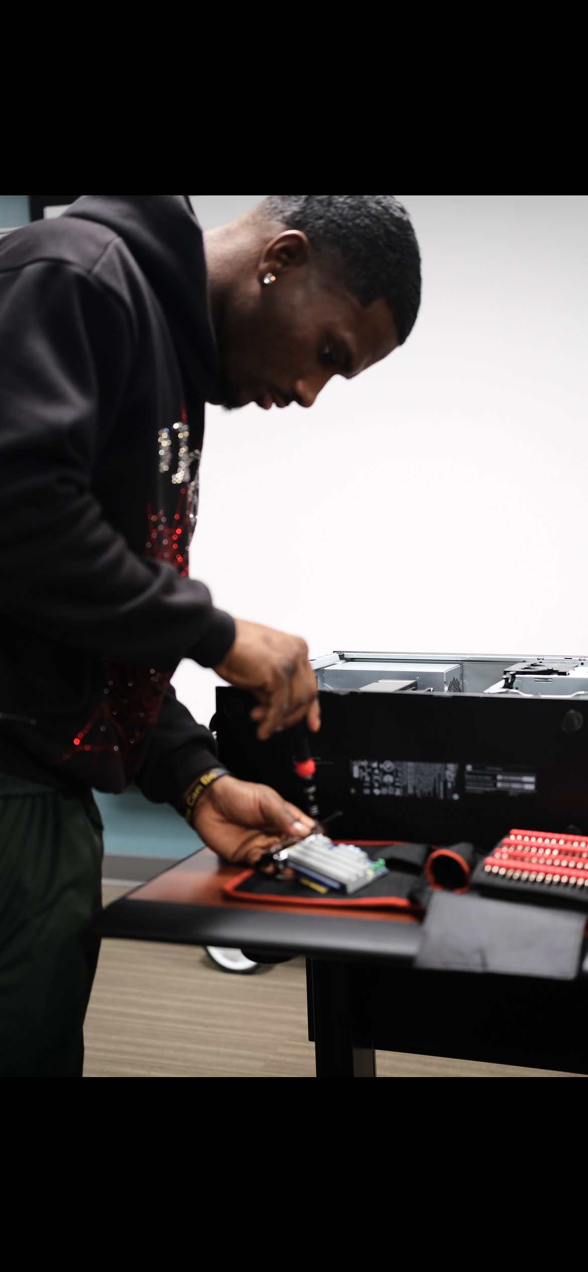 Student carefully handling a component