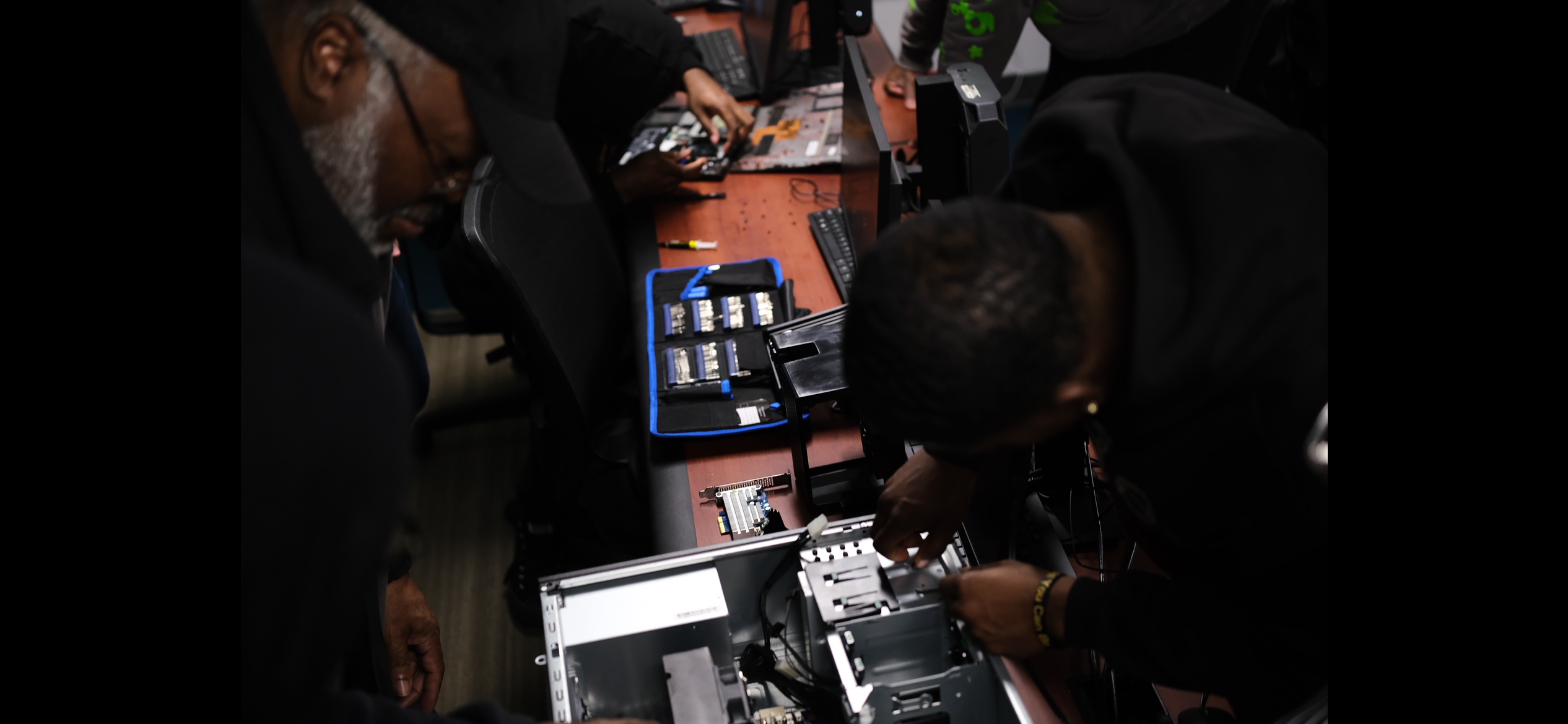 Group of students collaborating on PC assembly
