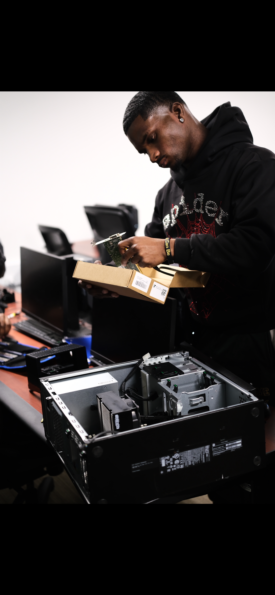 Student thinking with disassembled laptop in front